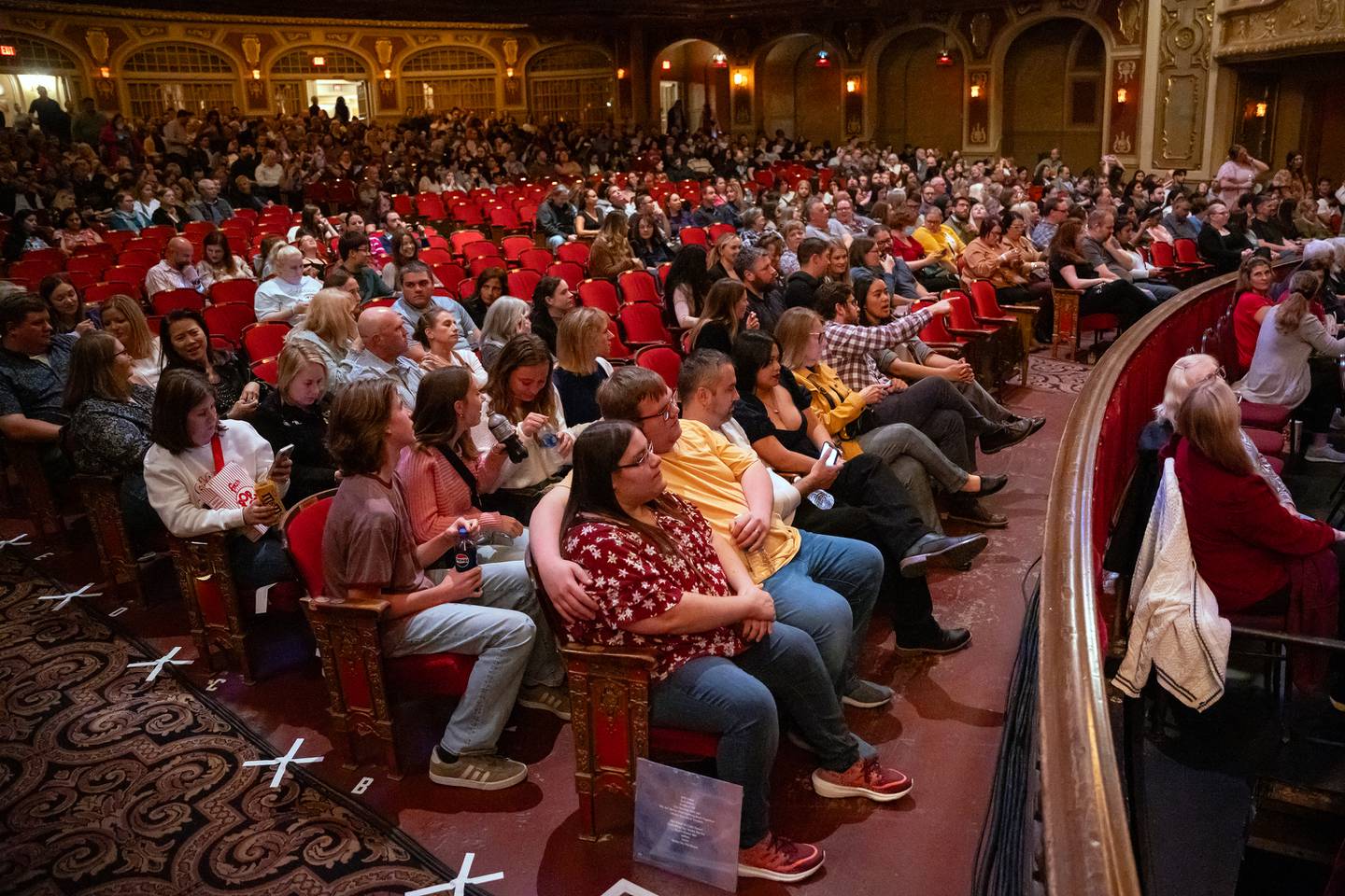 Concert attendees for the Vitamin String Quartet are seen in the venue for the reopening of the Rialto Square Theatre in Joliet, Ill. on Tuesday Oct. 22, 2024