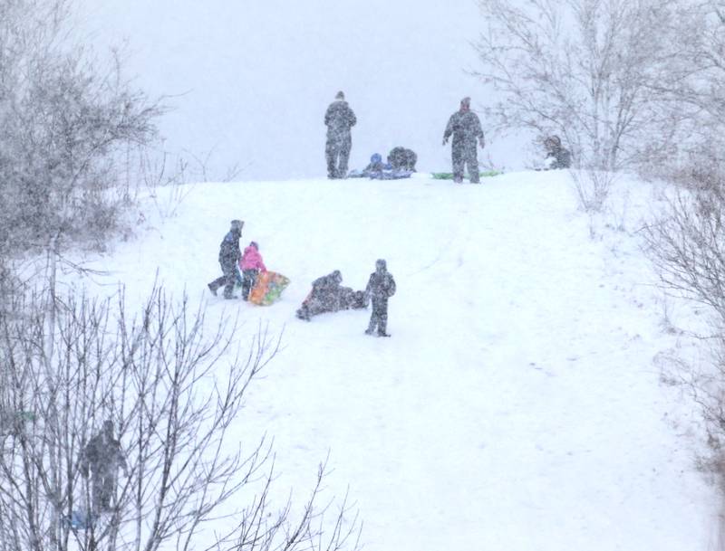 Kids sled down the big hill at Coal Miners Park on Tuesday, Jan. 9, 2024 in Spring Valley.