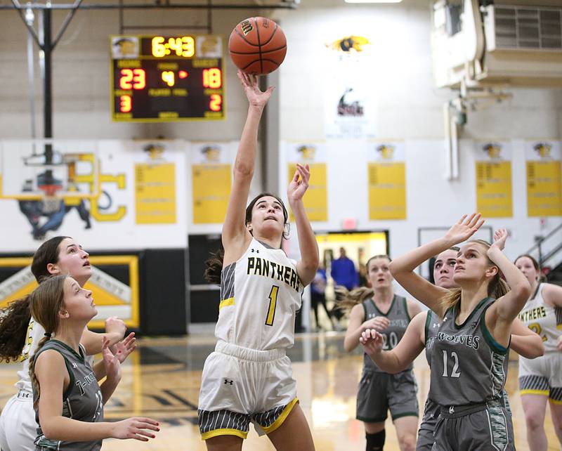 Putnam County's Ava Hatton runs in the lane to shoot a jump shot over Midland's Maddie Pyles and Ava Bade during the Class 1A Regional game on Monday, Feb. 13, 2023 at Putnam County High School.