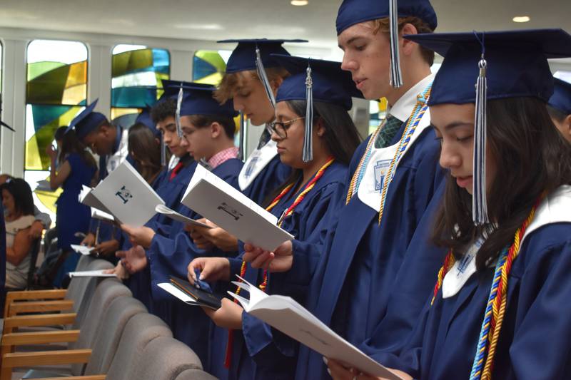 (Left to right) Alex Uribe, John Michael Urani, Matt Uphues, Michelle Toledano, Patrick Titzer and Amaris Teran recite the Alumni Pledge during Nazareth Academy’s commencement ceremony in La Grange Park on Sunday, May 21, 2023.