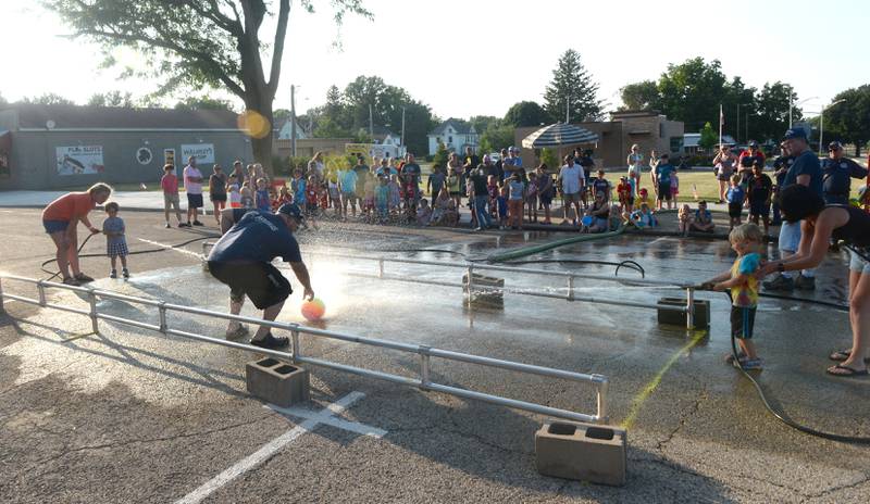 Kids battle it out with water and hoses provided  by the Mt. Morris Fire Department during the Let Freedom Ring on Monday.