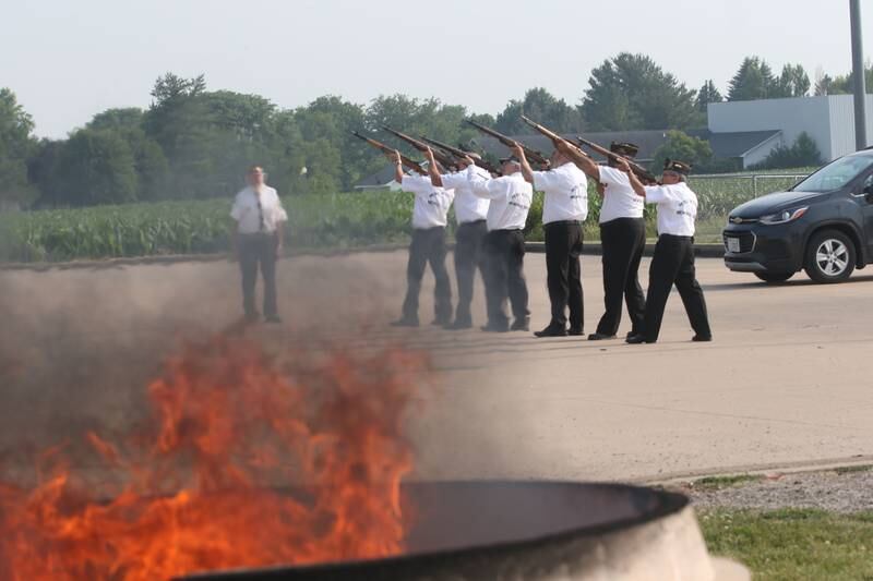Peru Veterans Memorial Group Veterans fire a 21 gun salute while flames emit from a burning cauldron full of American Flags during the Flag Retirement Ceremony on Wednesday, June 14, 2023 at Veterans Park in Peru. Each year on Flag Day, the group retires flags while holding a ceremony with Boy Scout Troop 123 and Cub Scout 3709 from Peru.