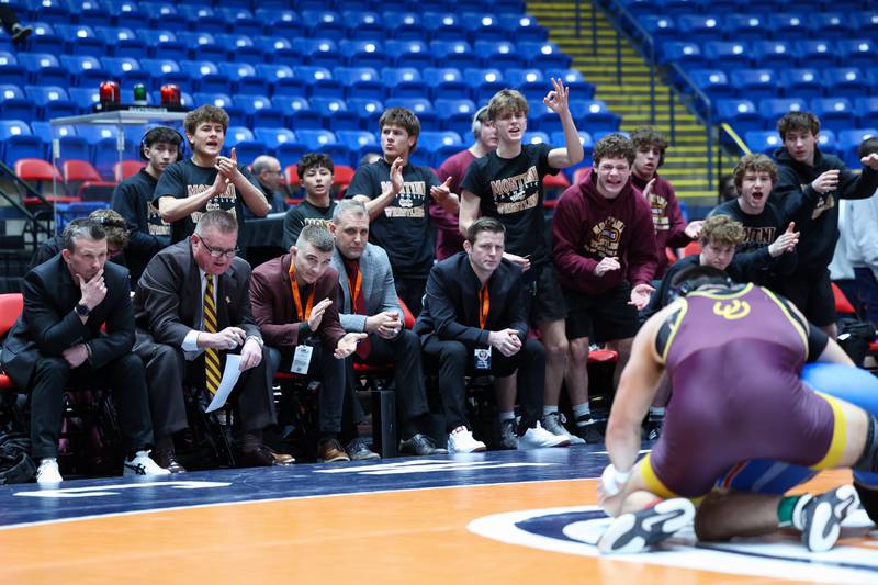 Montini's bench cheers on Santino Tenuta as he wrestles Marmion Academy's Grayson Garcia in the 165-pound match during Marmion Academy's victory over Montini in the IHSA Class 3A Dual Team State championship on Saturday, Feb. 28, 2026.