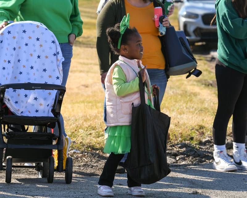 Elle Thompson, 3, of North Riverside is all smiles as she waves and waits for candy to be thrown her way during the Countryside St. Patrick’s Day parade on Saturday March 2, 2024.