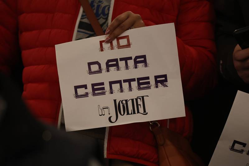 Residents holds signs against the proposed Data Center at the City of Joliet Plan Commission meeting on Thursday, March 5, 2026 in Joliet.