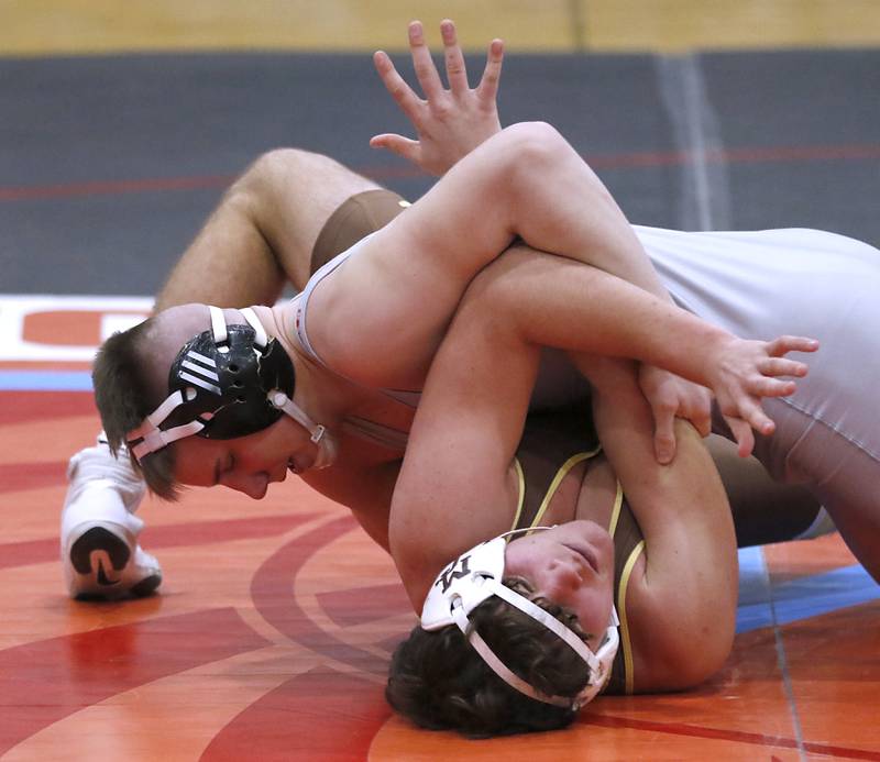 Marian Central's Jimmy Mastny tries to pin Mt. Carmel's Kenneth Segerson in their 190-pound match during a triangle wrestling meet on Saturday Jan. 11, 2025, between Marian Central, Joliet Catholic, and Mt. Carmel at Marian Central High School in Woodstock.