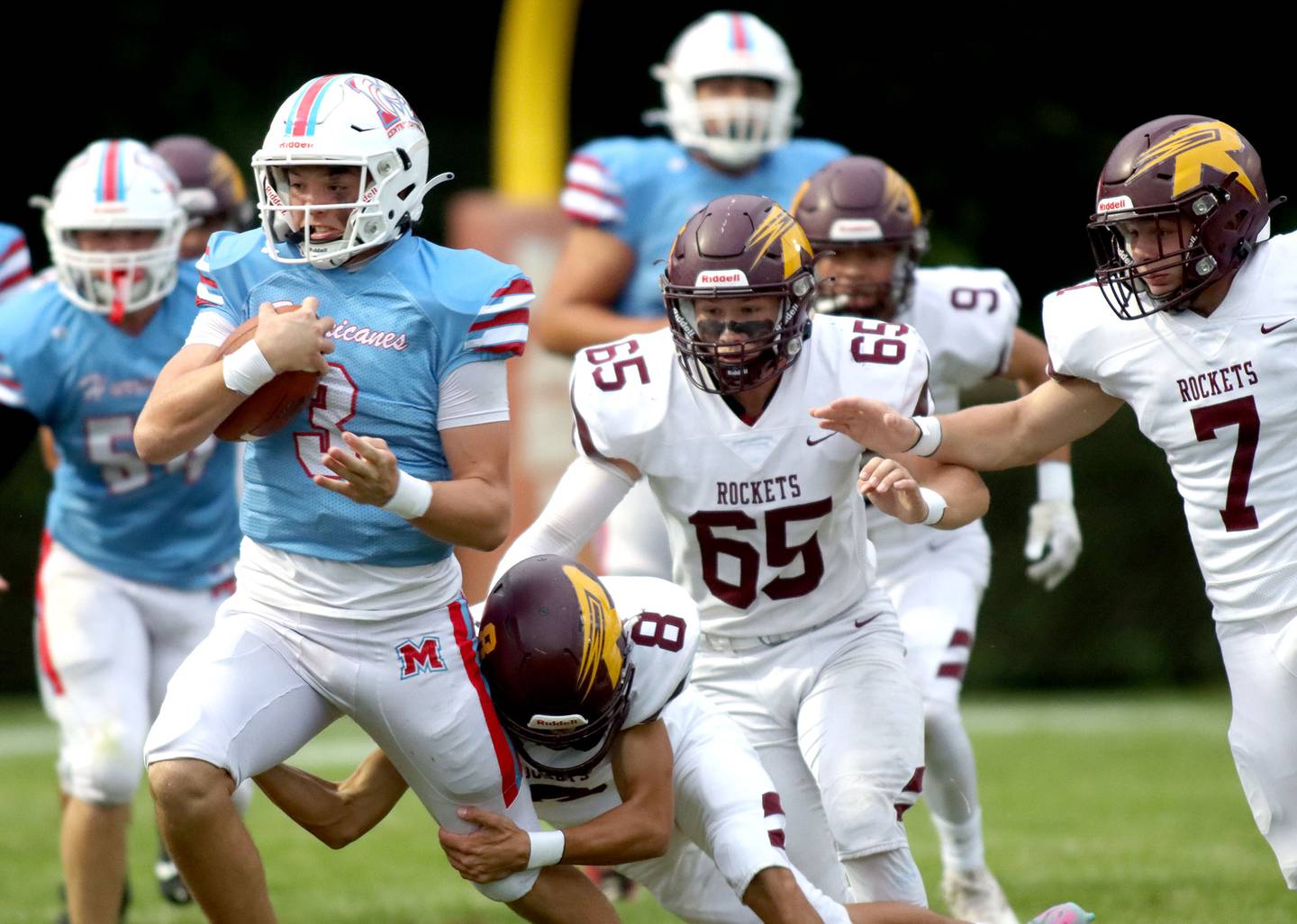 Marian Central’s Colin Hernon is brought down by Richmond-Burton’s Joseph Larsen on a quarterback keeper in varsity football at George Harding Field on the campus of Marian Central High School in Woodstock on Friday, August 29, 2025.