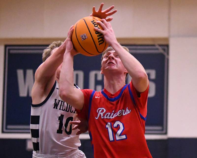 Glenbard South's Mitchell Erickson (12) makes a basket while being defended by West Chicago's Peter Bovey (10) during the game on Friday Jan. 3, 2025, held at West Chicago High School.