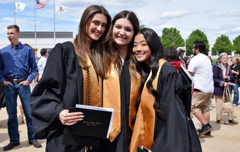 Three graduates pose for a photo together after the commencement ceremony of Sycamore High School's Class of 2022, held Sunday, May 22, 2022 at Northern Illinois University's Convocation Center in DeKalb. From left, Trista Fioretto, Kaityln Levy and Jalyna Polichnowski.