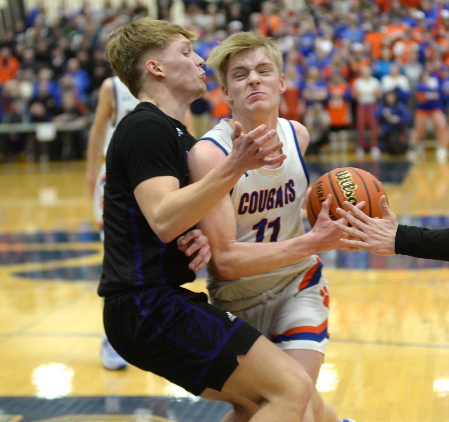 Eastland's Trevor Janssen (11) protects the basketball from a Pecatonica player during the championship game of the 1A River Ridge sectional on Friday, March 1, 2024 in Hanover.