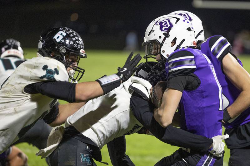 Dixon’s Jagger Kemp is pushed out of bounds against Woodstock North Friday, Oct. 31, 2025, in the Class 4A football first round playoffs.