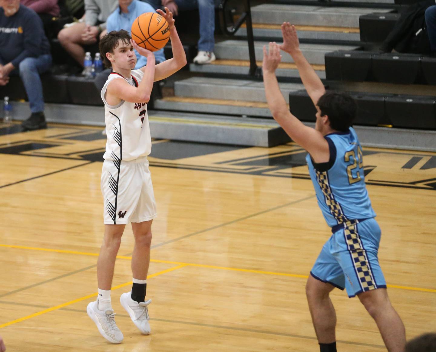 Woodland's Nolan Price shoots a jump shot over Marquette's Matthew Graham during the Tri-County Conference Tournament championship on Friday, Jan. 30, 2026 at Putnam County High School.
