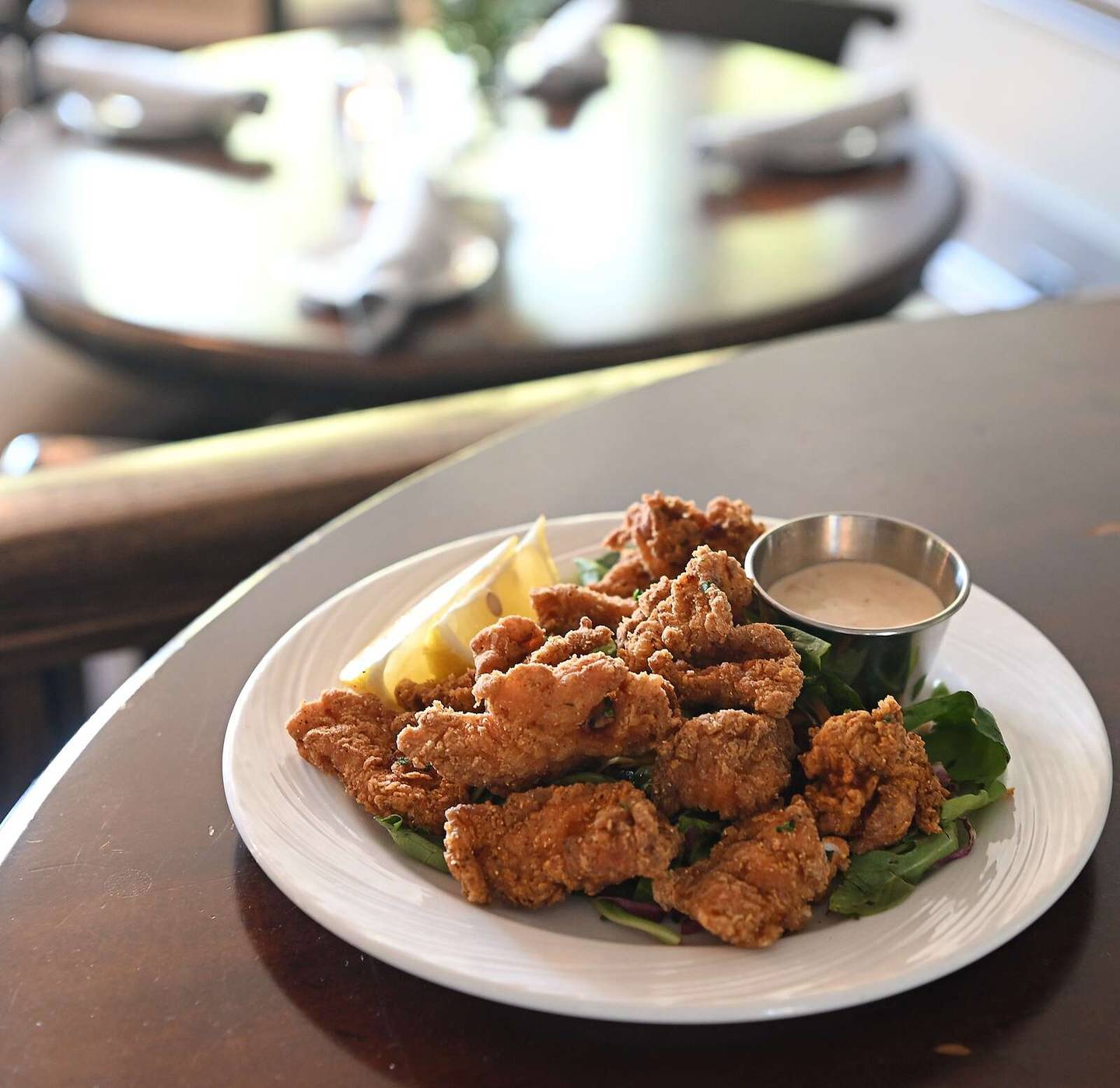 Alligator bites are coated with a spicy cornmeal breading and served with a Cajun rémoulade sauce at The Patten House.