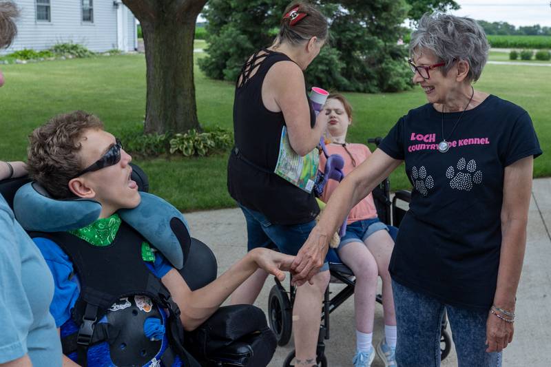(left to right) Decan shakes hands with Joanne of Loch Countryside Kennel on Friday, June 27, 2025 at Loch Countryside Kennel in Peru.