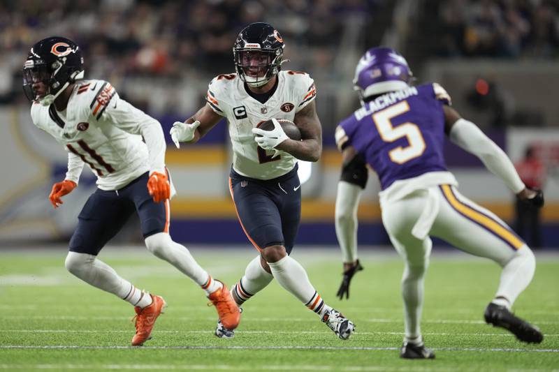 Chicago Bears wide receiver DJ Moore runs from Minnesota Vikings cornerback Mekhi Blackmon during the second half, Monday, Nov. 27, 2023, in Minneapolis.