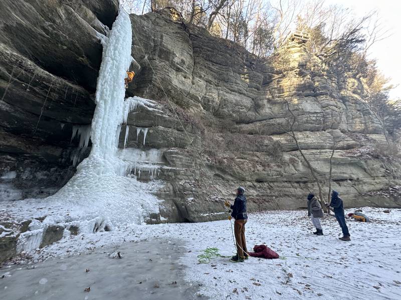 Gerry Voelliger of Bettendorf, Iowa, (top) climbs up a 80-foot frozen waterfall inside Wildcat Canyon on Friday, Jan. 24, 2025, at Starved Rock State Park.