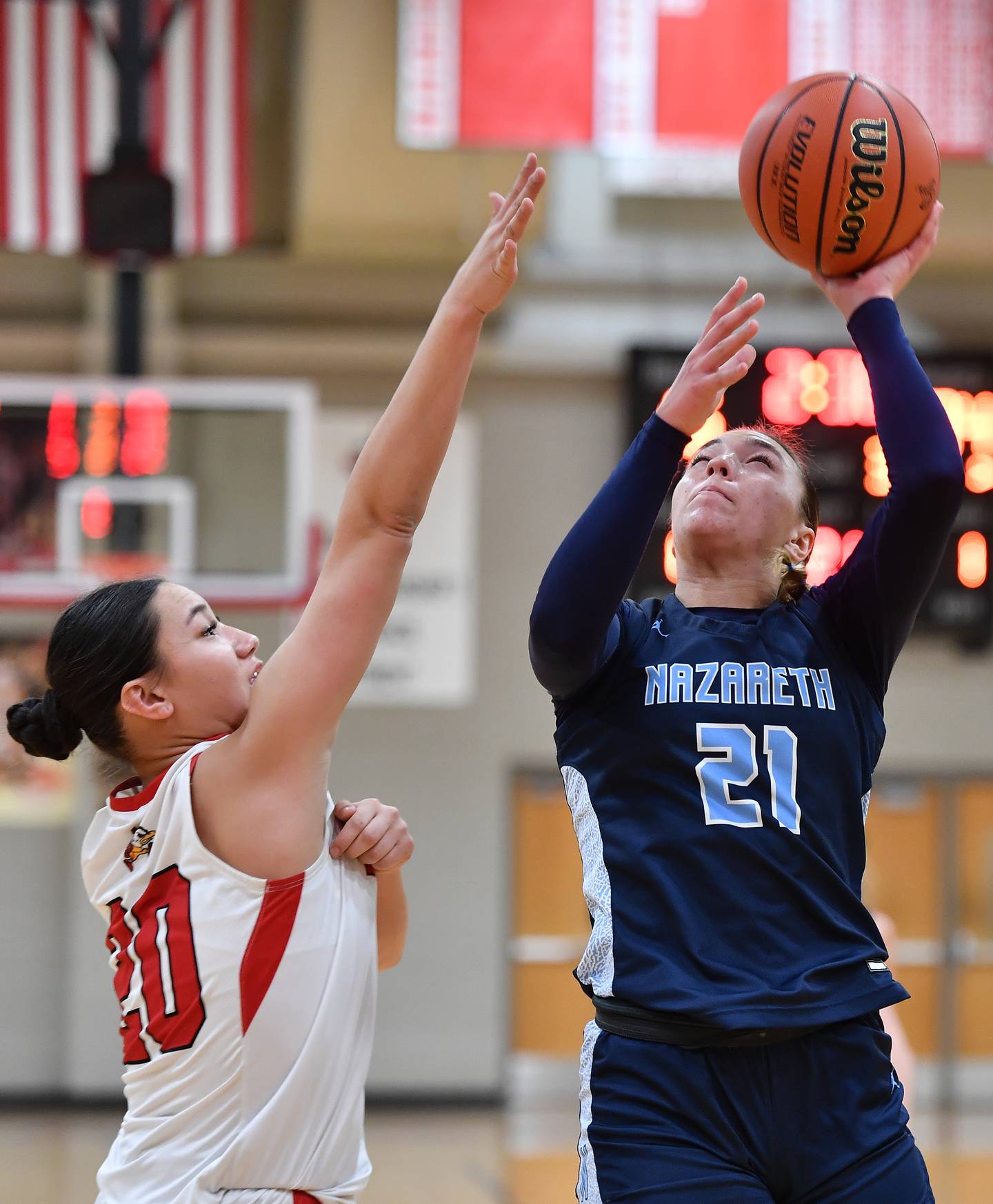 Nazareth's Olivia Austin (21) shoots over Benet's Emma Briggs during a game on Dec. 13, 2023 at Benet Academy in Lisle.