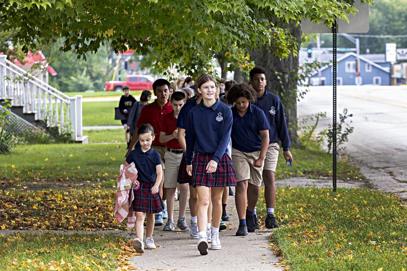 Students from St. Mary’s in Dixon return from their annual “Walk, Pray, Love-a-Thon” Friday, Sept. 22, 2023. After a performance by the school band, staff and students paraded down to the riverfront with signs spreading their love and praise.