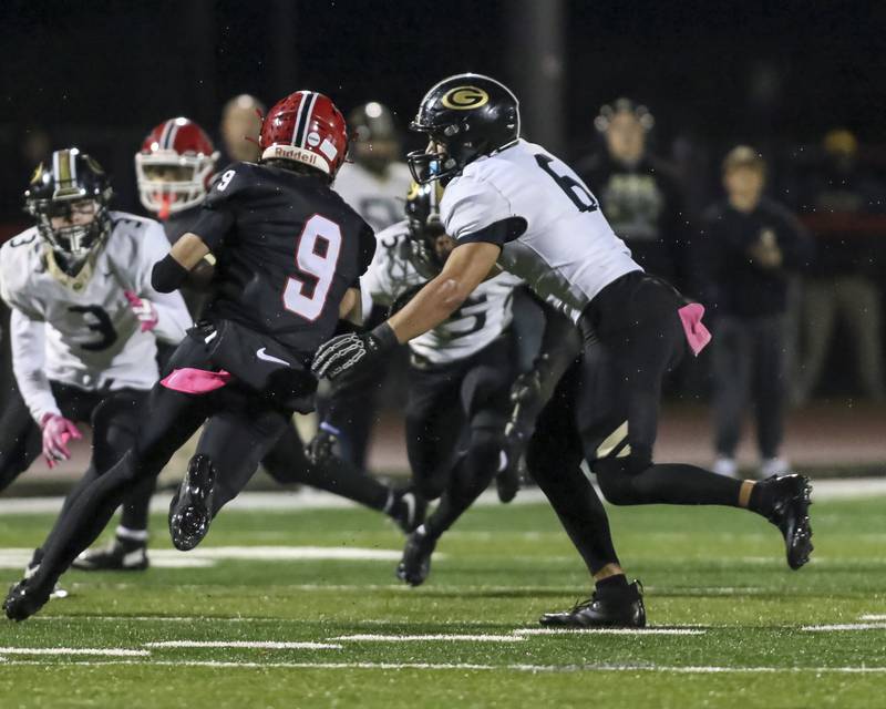 Glenbard North's Tyler Hvorcik (6) closes in Yorkville's A.J. DiVito (9)during Class 7A first round football game between Glenbard North at Yorkville. Friday, Oct 31, 2025 in Yorkville.