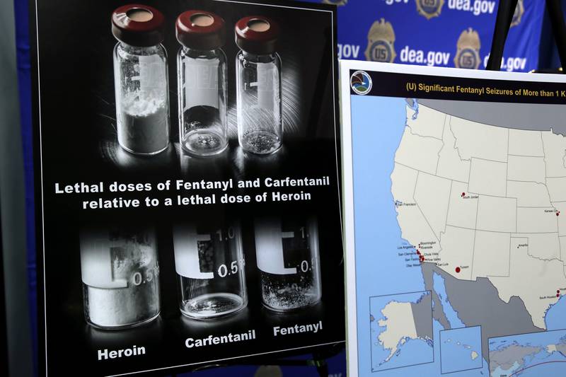 Posters comparing lethal amounts of heroin, fentanyl, and carfentanil, are on display during a news conference about the dangers of fentanyl, at DEA Headquarters in Arlington, Virginia, Tuesday, June 6, 2017.