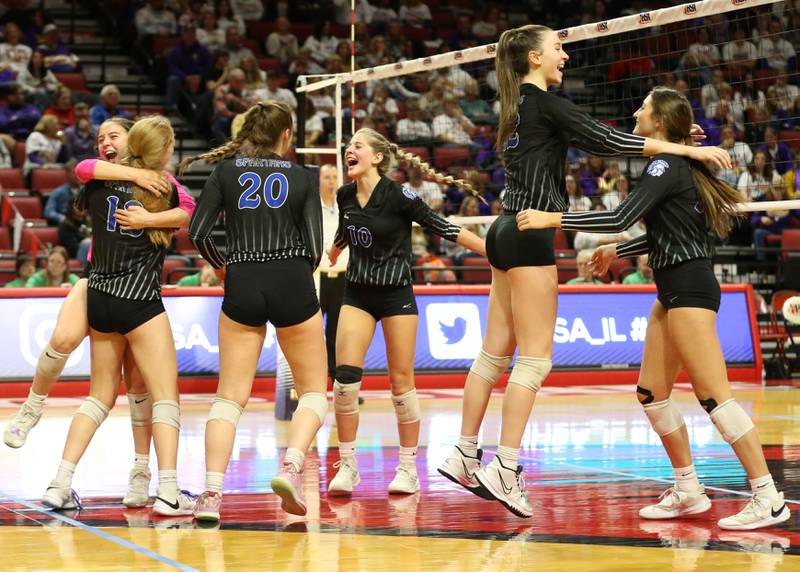 Members of the St. Francis volleyball team celebrate after defeating Joliet Catholic in the Class 3A semifinal game on Friday, Nov. 11, 2022 at Redbird Arena in Normal.
