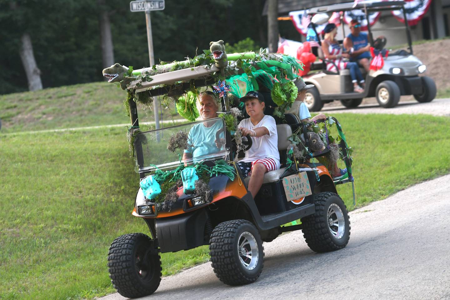The Welty family decorated their golf cart as a Cajun Swamp Tours cart during the Grand Detour Golf Cart Parade on July 3. Here, Finn Sommers, 10, the grandson of Tom Welty drives the cart as Tom rides in the passenger seat. Finn and his brother and sister Ryder, 8, and Isla 5, had the idea for this year's decorating theme after visiting Mississippi and taking a swamp tour. Ryder and Isla, along with their grandmother, Steffaney, rode in the back.