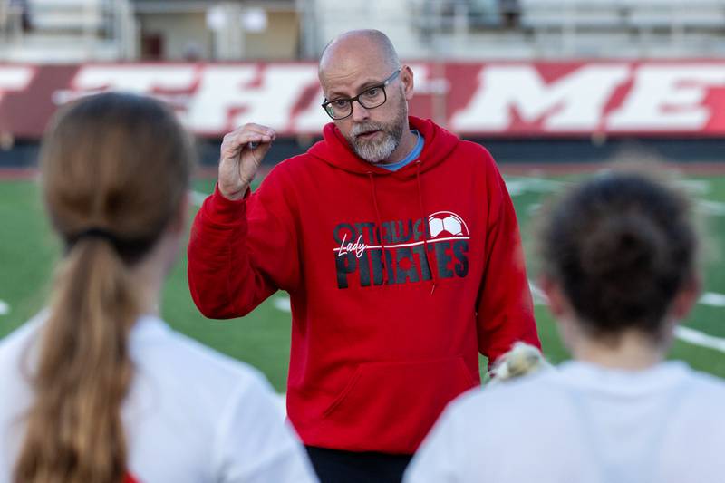 Ottawa Head Coach Kevin Olesen talks to team during halftime on Tuesday, May 21, 2025 at Malone Field in Metamora.