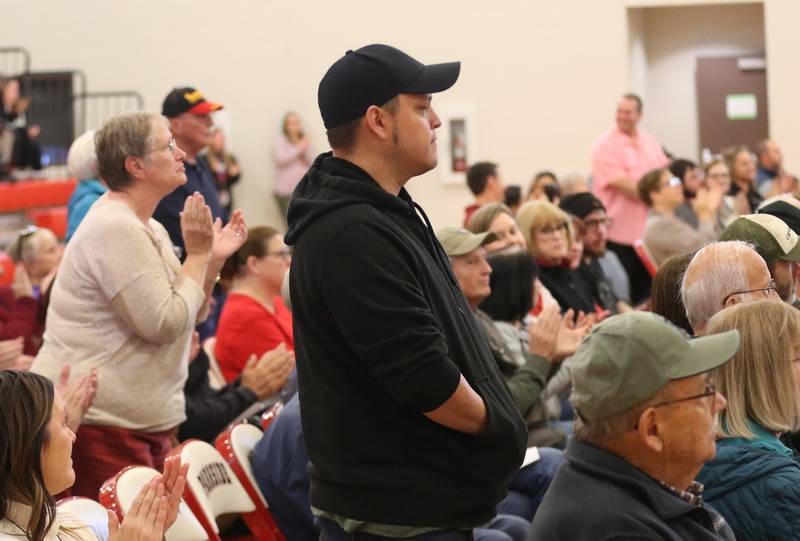 United States Marine Veterans stand to be recognized during the annual Veterans Day Program on Monday, Nov. 11, 2024 at Parkside Middle School in Peru.