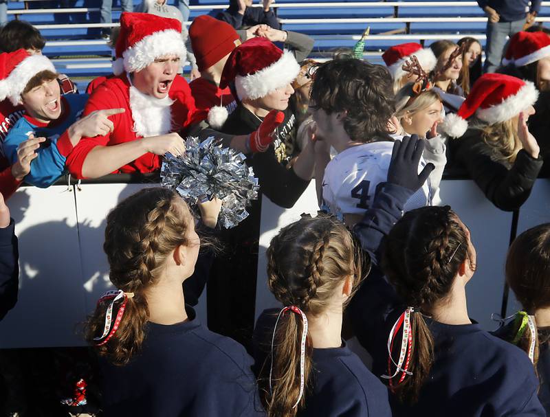 Fans and cheerleaders cheer for Cary-Grove's Logan Abrams after Cary-Grove defeated Lake Zurich in a IHSA Class 6A semifinal playoff football game on Saturday, Nov. 18, 2023, at Lake Zurich High School.