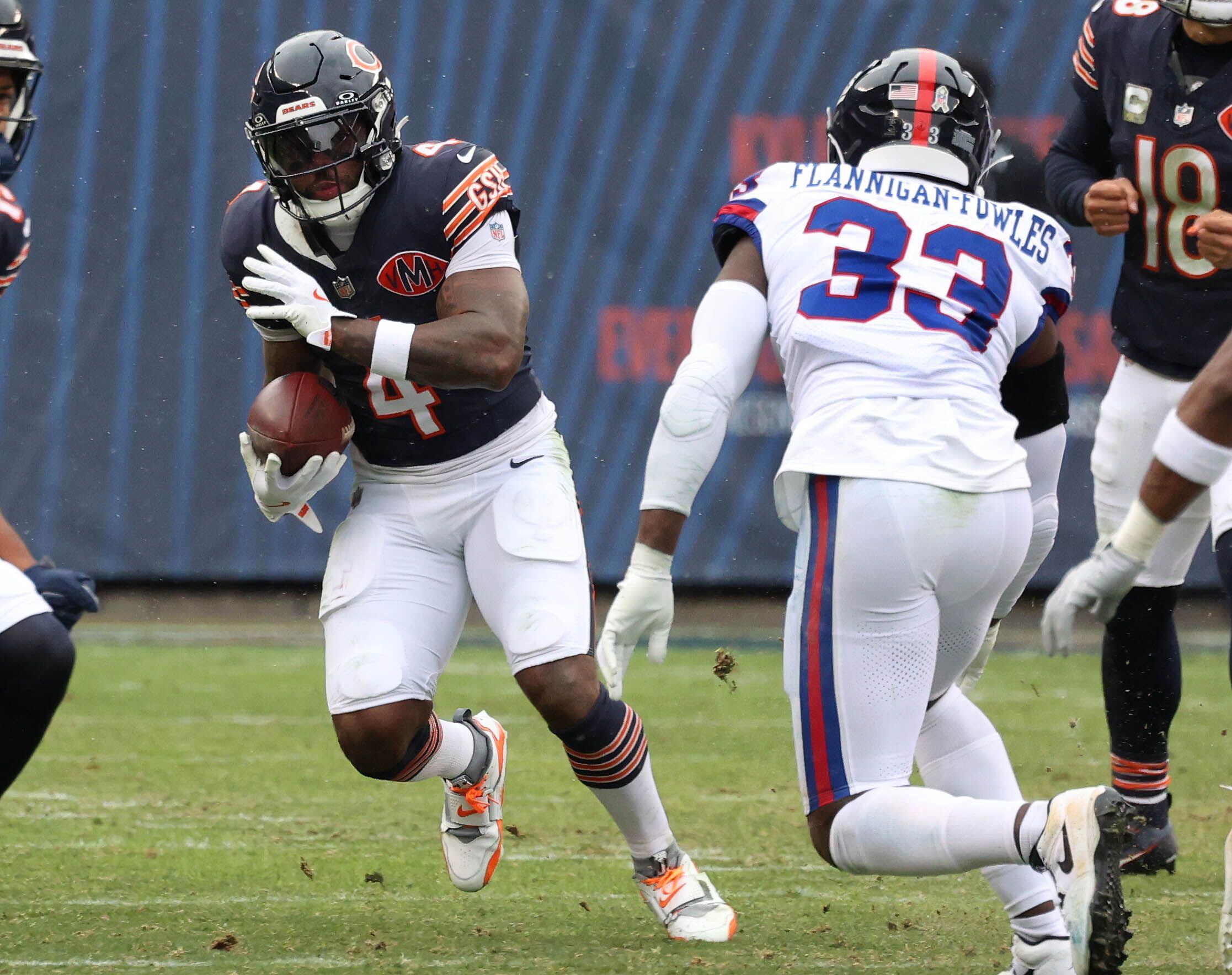 Chicago Bears running back D'Andre Swift looks to get by New York Giants linebacker Demetrius Flannigan-Fowles Sunday, Nov. 9, 2025, during their game at Soldier Field in Chicago.