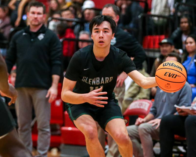 Glenbard West's Julian Yeh (14) looks to pass during their basketball game between Glenbard West at Hinsdale Central, Friday  Dec 6, 2024  in Hinsdale.