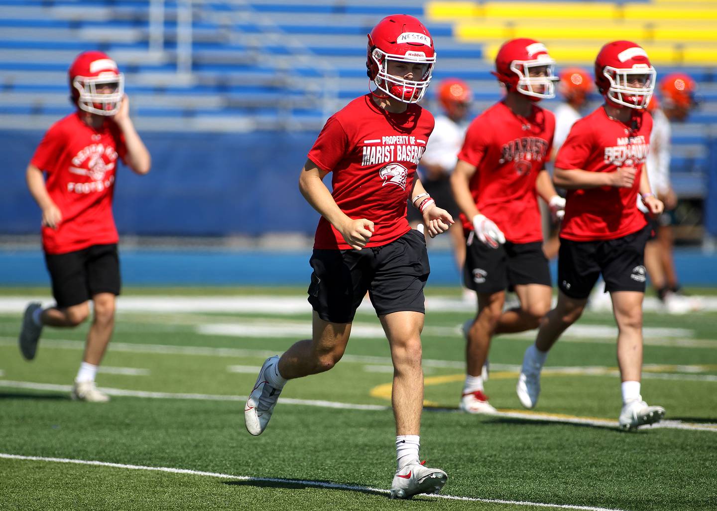 Marist players warm up during a 7-on-7 tournament hosted by Lyons Township on Thursday, July 1, 2021. York, Wheaton Warrenville South and Lyons Township also participated in the tournament.