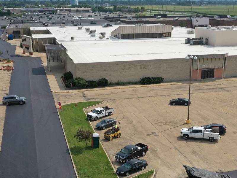 Workers with Advanced Asphalt pave the north entrance to the Peru Mall on Monday, July 17, 2023 in Peru. The project is on private property and is not city funded.