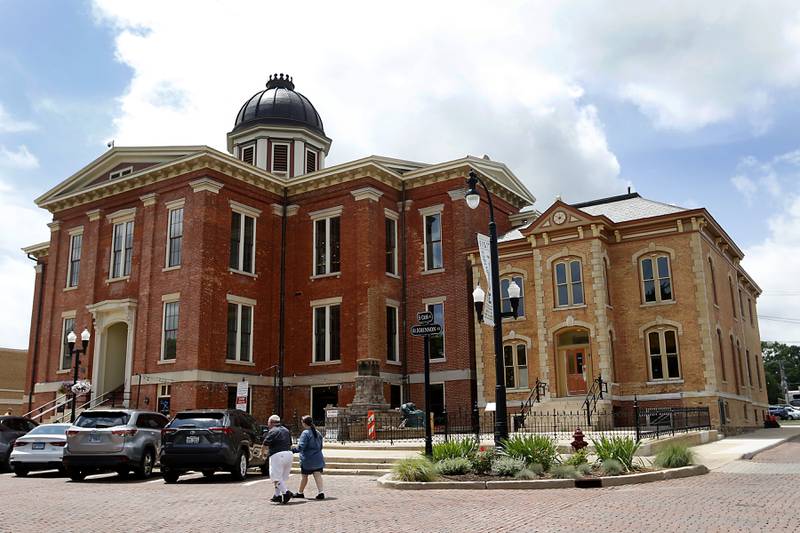 A couple walks past the newly remodeled Old Courthouse Center in Woodstock on Thursday, July 13, 2023, during a tour of the building.