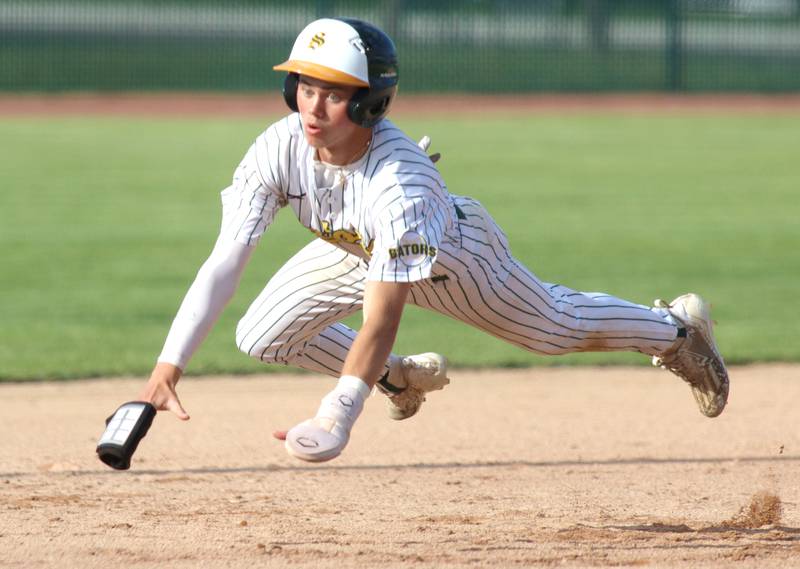 Crystal Lake South’s Xander Shevchenko lands safely at third base before scoring on an error against Lake Forest in Class 3A baseball regional action at Crystal Lake Thursday.