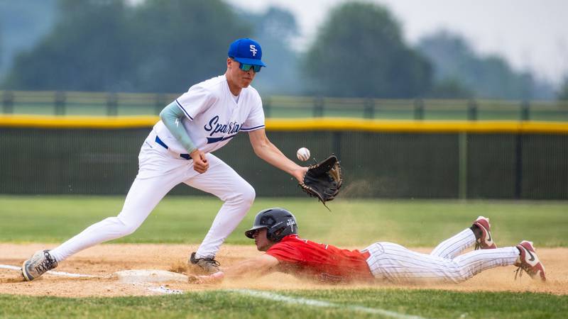 St. Francis High School third baseman Chase Grigonis misses a throw from the catcher making the Benet Academy runner safe during the Class 3A Kaneland Sectional final at Kaneland High School in Maple Park on Saturday, June 7, 2025.
