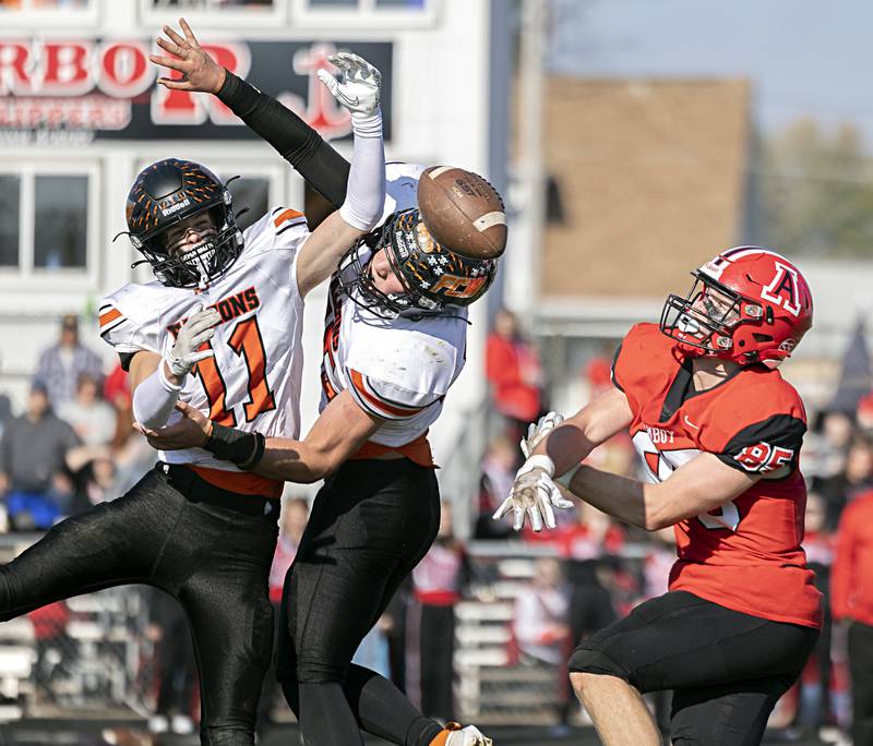 FCW’s Jonathan Moore (11) and Kesler Collins break up a pass intended for Amboy’s Brennan Blaine on Saturday, Nov. 4, 2023, in the I8FA playoffs in Amboy.