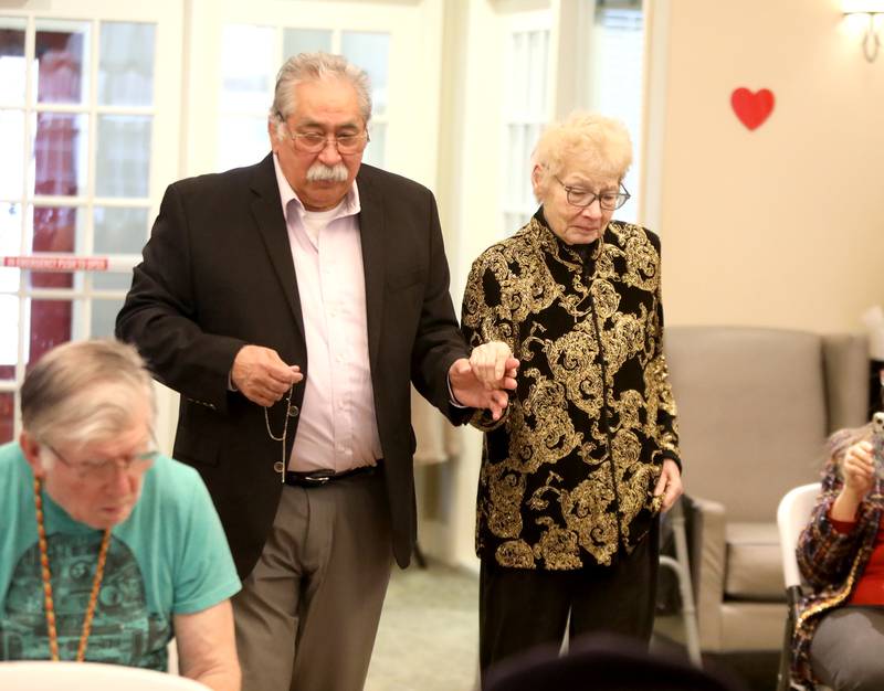 Richard and Christine Garcia, who have been married for 55 years, go down the aisle before renewing their wedding vows on Friday, Feb. 14, 2025 at Churchill Place, an Anthem Memory Care community in Glen Ellyn.