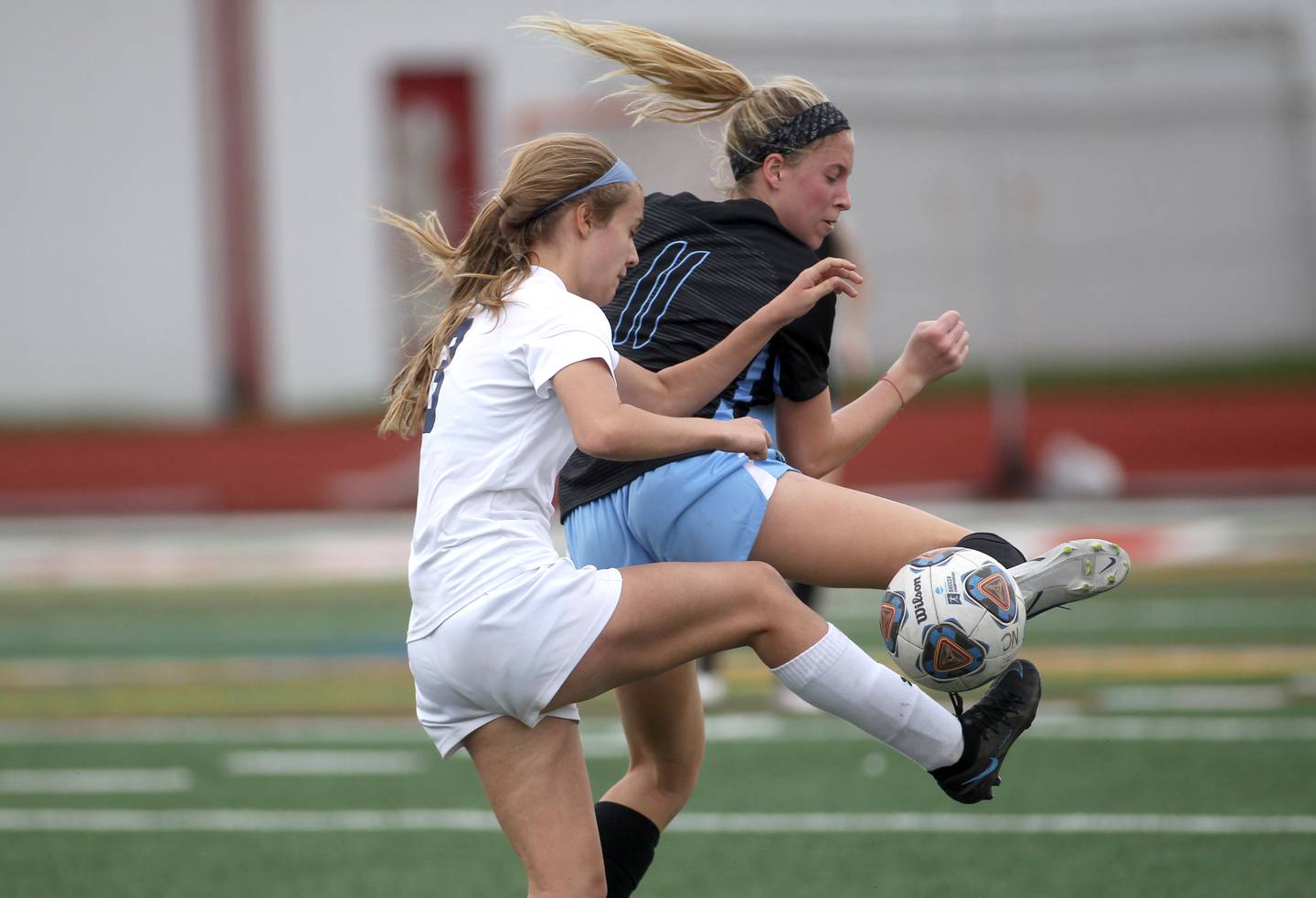 Oswego East’s Anya Gulbrandsen (3) and St. Charles North’s Sidney Timms go after the ball during a Naperville Invitational game at Naperville Central on Saturday, April 23, 2022.