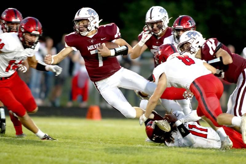 Prairie Ridge’s Tyler Vasey soars as he picks up some yardage against Huntley in football Friday night at Crystal Lake.