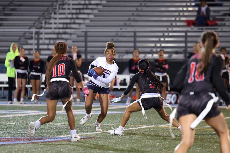 Yorkville's Oswego's Alexis Fomby runs the ball as Yorkville defenders close in during the Foxes' 2-1 overtime victory over Oswego in the IHSA Kankakee Regional championship game on Thursday, Oct. 9, 2025.