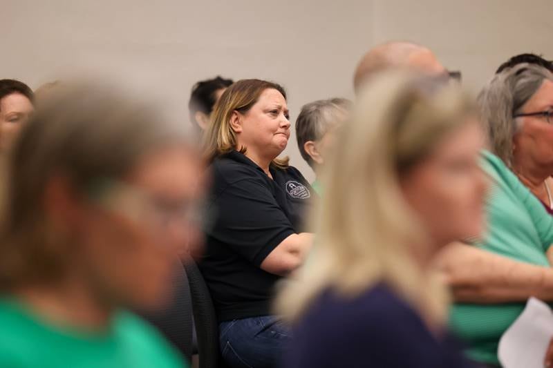 Surrounded by Fortitude Community Outreach supporters, executive director Dawn Broers listens to supporters speak ahead of the Kankakee City Council's vote on a conditional use permit to allow Fortitude to operate a shelter at 970 E. Court St. in Kankakee during the meeting on Monday, Sept. 15, 2025. The conditional use permit request was rejected by a 12-0 vote.