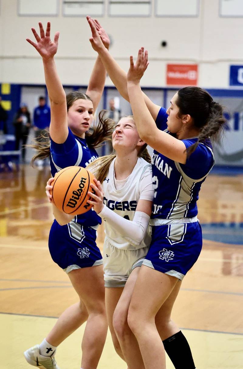 Princeton's Payton Brandt squeezes the through the Newman defense Saturday night at Prouty Gym.