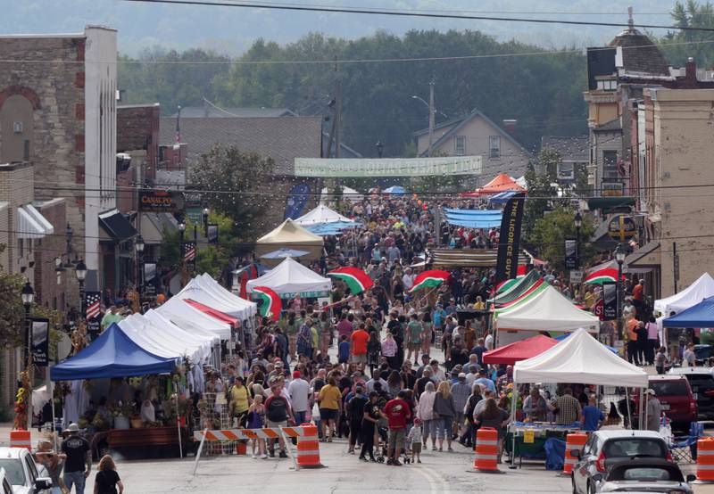 A crowd of people walks down Mill Street on Sunday Oct. 10, 2021 during the 51st annual Burgoo festival downtown Utica. The early morning rain detoured some of the crowd but the festival produced a steady crowd as it is spreadout all over the village.