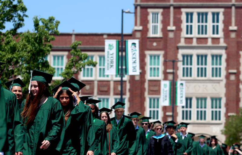 Members of the Class of 2024 marched to the stadium as York High School held its graduation at the school in Elmhurst on Sunday.