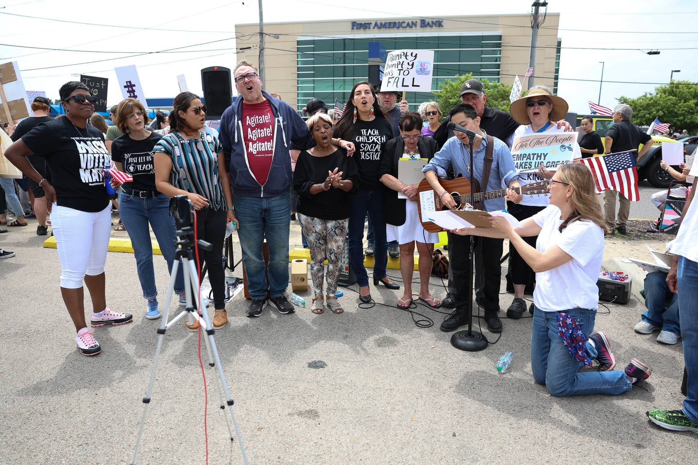 Rally speakers sing patriotic songs along West Jefferson Street near Larkin Avenue for the No Kings Day protest on Saturday, June 14, 2025 in Joliet.