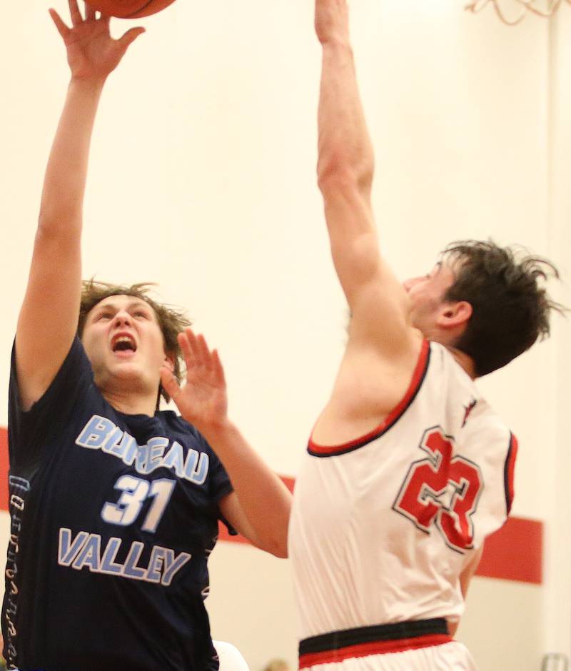 Bureau Valley's Blake Foster lets go of the ball over Hall's Braden Curran on Tuesday, Feb. 6, 2024 at Hall High School.