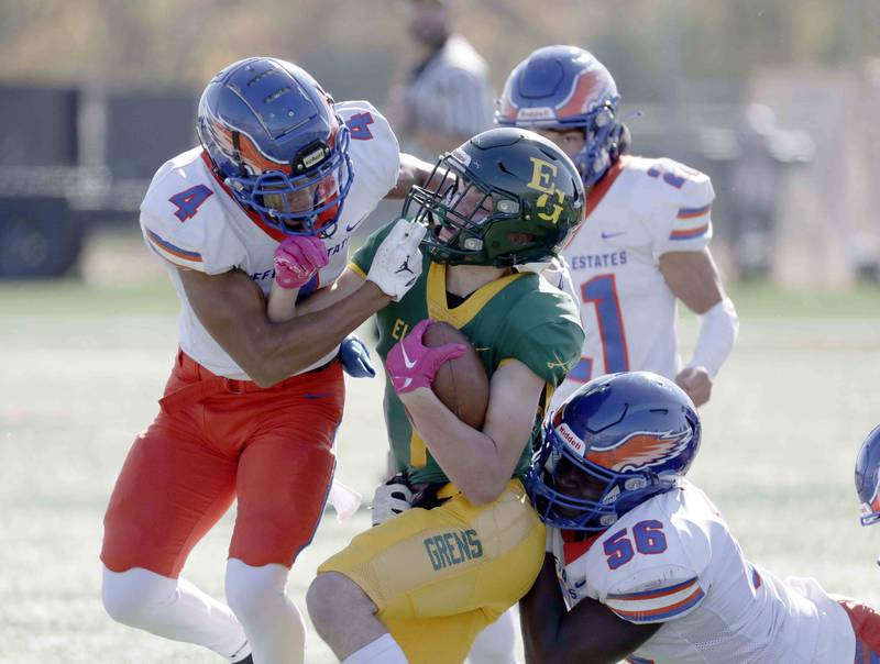 Elk GroveÕs Lucas Rogers, 7, is brought down by Hoffman Estates' Xavier Martnez, 4, and Kehinde Akintunde, 56, Saturday October 29, 2022 in Elk Grove Village.