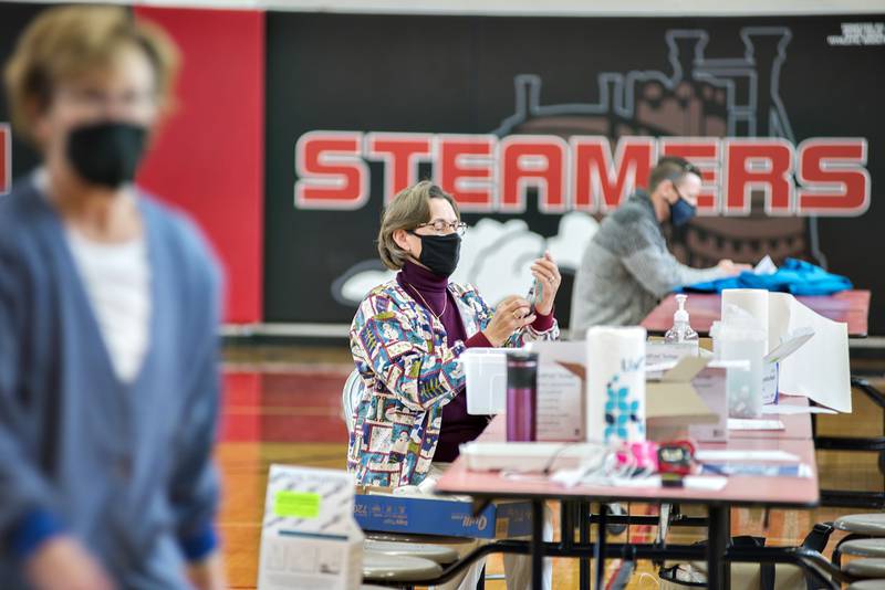 Evette VonHolten draws up vaccine into syringes Wednesday morning at Fulton High School as the Whiteside Health Department hosts a clinic to inoculate selected residents of the county.