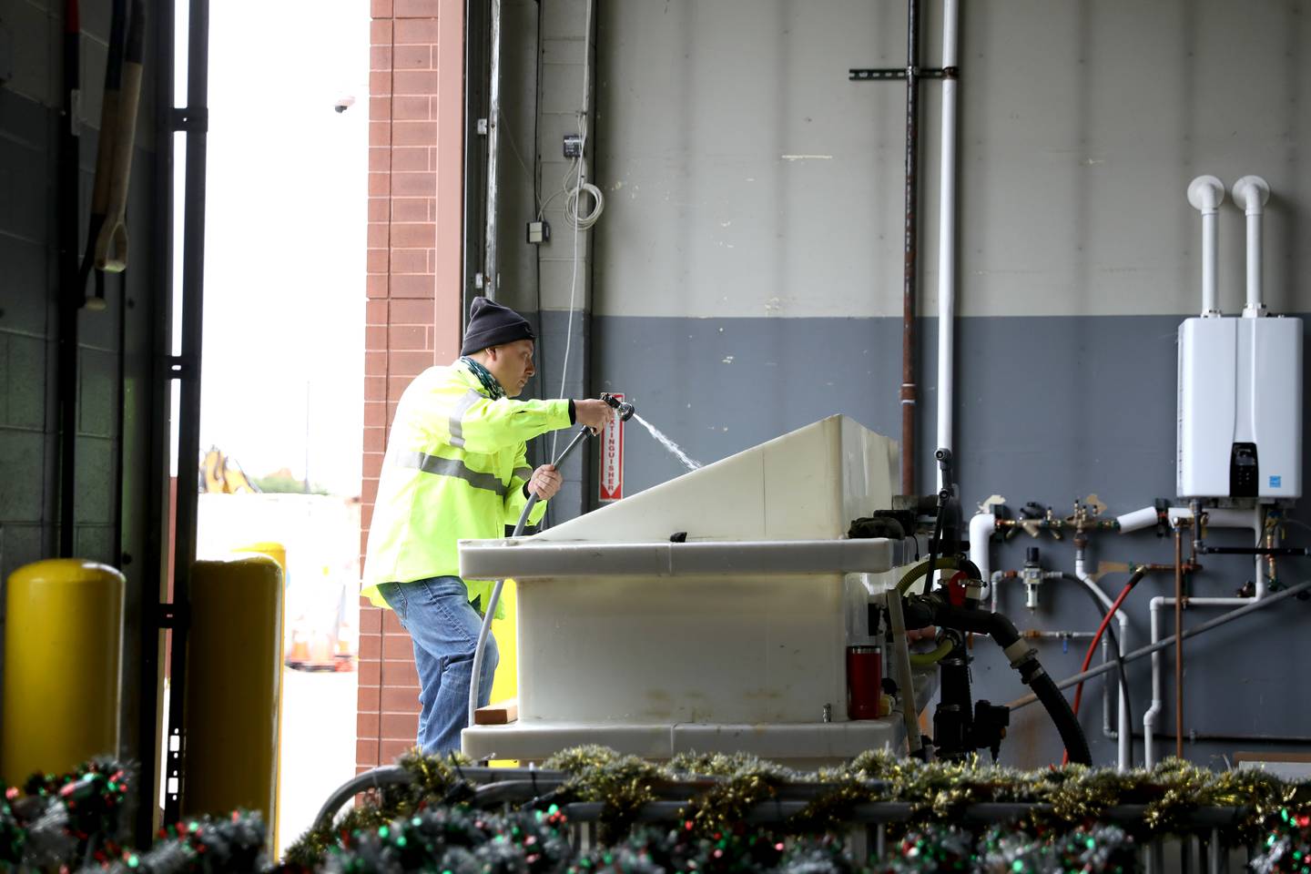 Ramon Palomo, Oswego public works technician, adds water to a brine solution to be used this winter to keep ice off the roads.